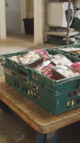 Vertical-Video-Showing-Interior-Of-UK-Food-Bank-Building-With-Fresh-Food-Being-Sorted-For-Delivery-2